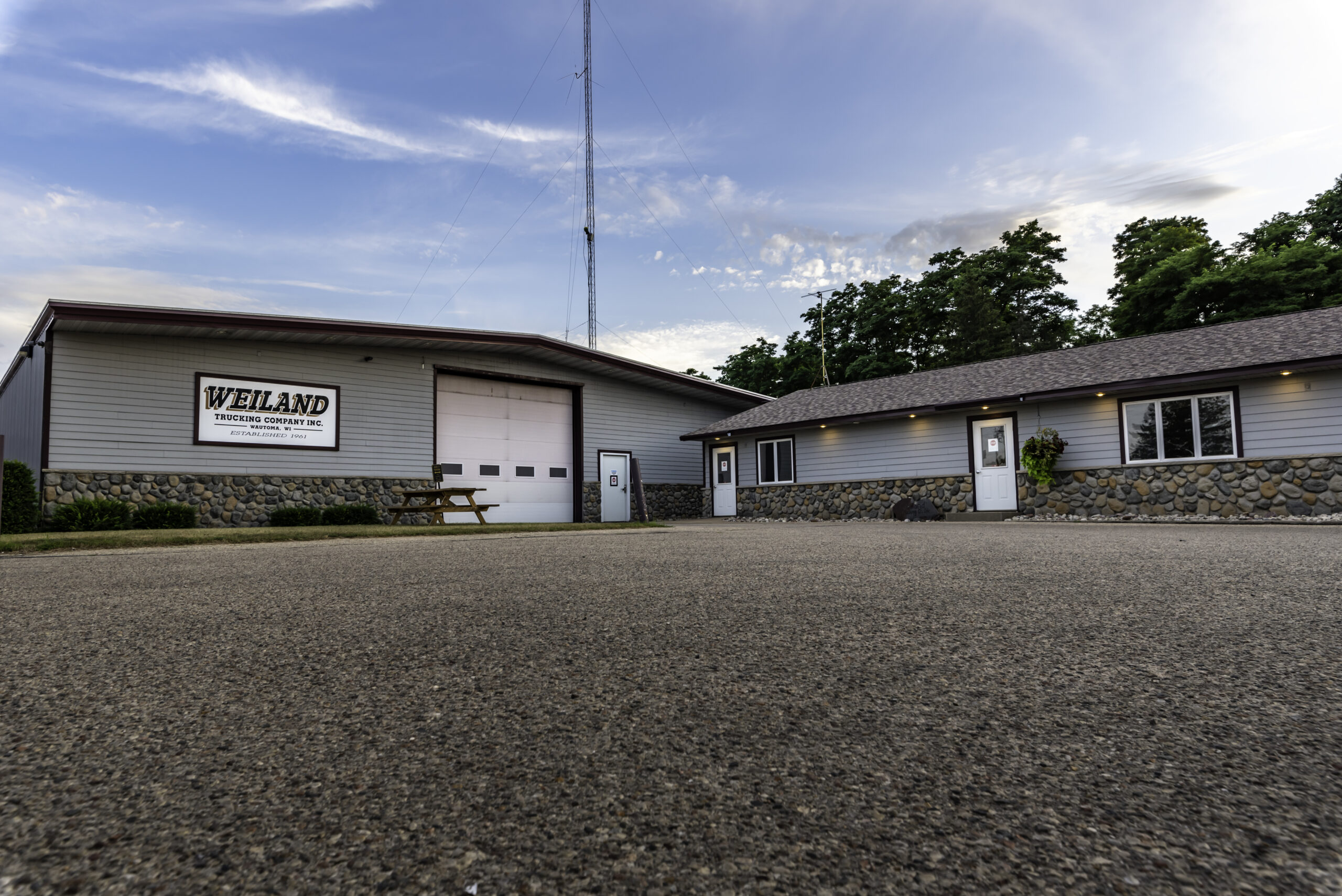 Weiland Trucking Company office building with stone foundation and communication tower
